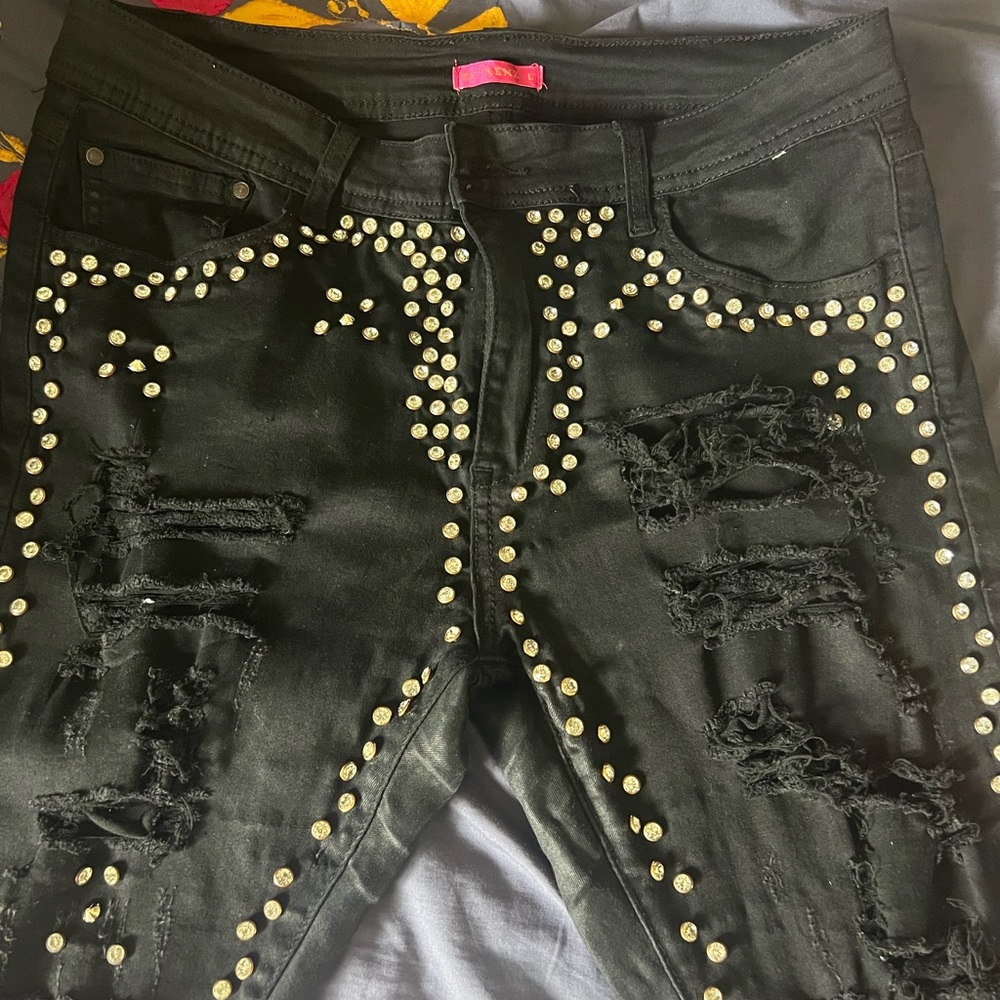 Black pant with silver studs and ripped.